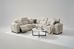 Beige sectional sofa in a living room with sunlight streaming through curtains.